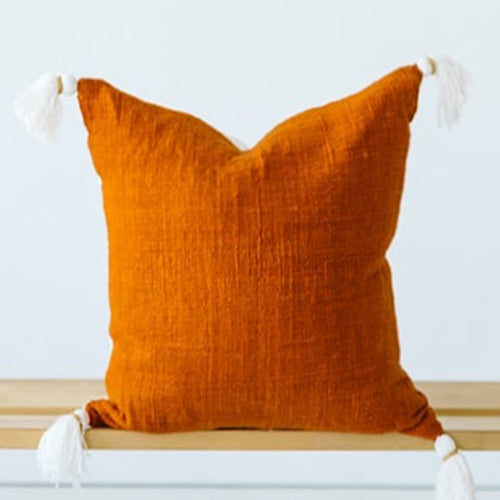 rust orange throw pillow with tassels